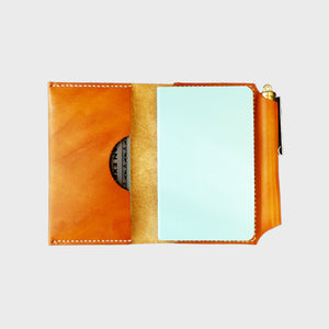 Tan leather wallet with white stitching, journal, pen, image